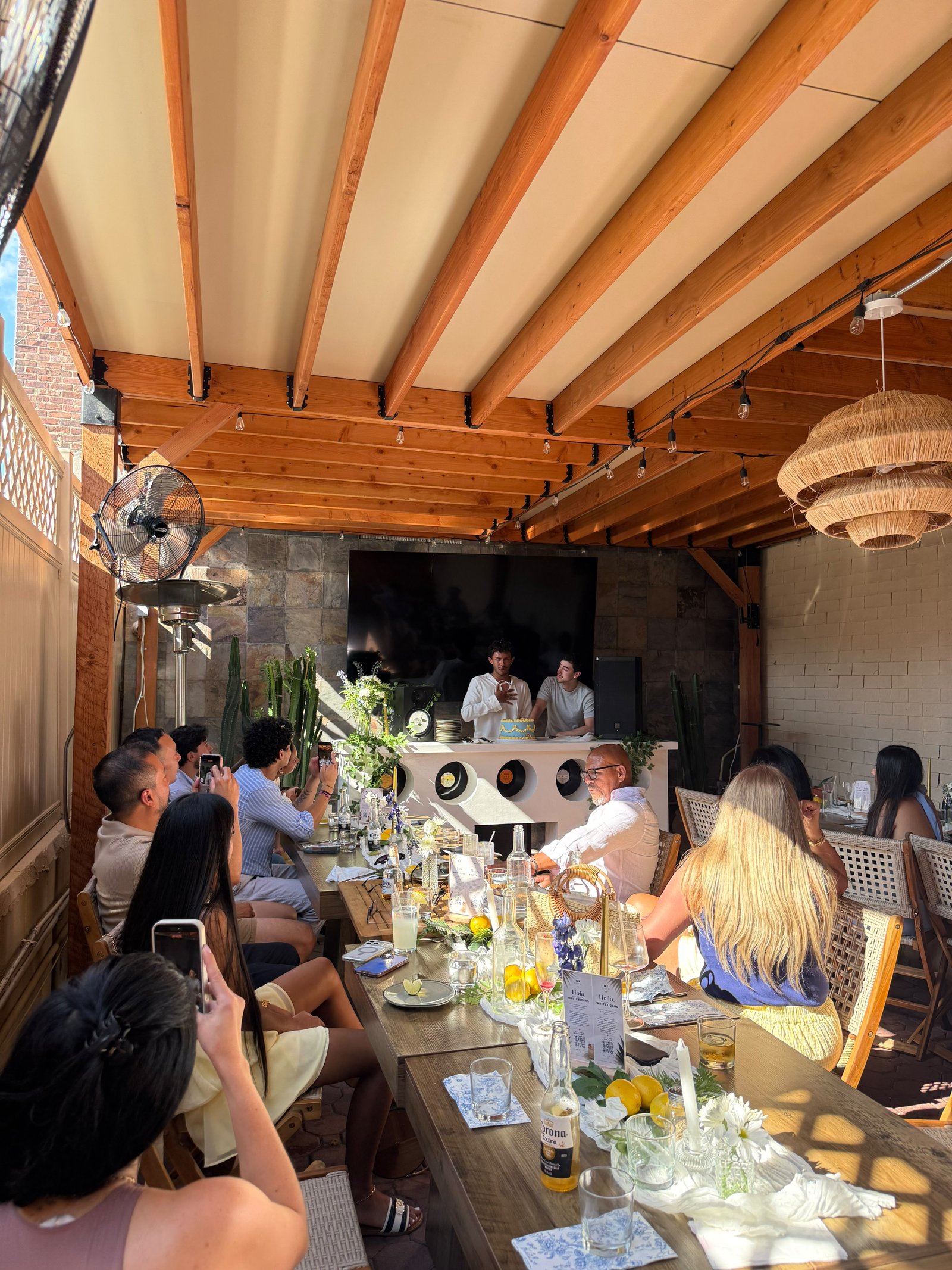 Guests celebrating a birthday with a DJ on the Whitexicans patio in Queens